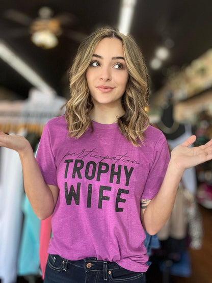 Let your wife know she's a trophy with this stylish Trophy Wife Tee. Featuring fun and cheeky messaging, she'll love the look and sentiment. Even when she's in her messy hair, sweatpants, and munching on take out food, she's still a winner in your eyes!